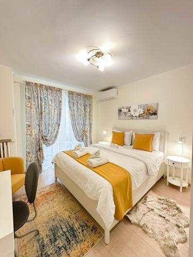 a bedroom with a large bed and a window at Sunrise Apartments City Center in Bucharest