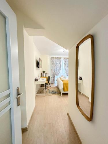 a bedroom with a mirror and a bed and a desk at Sunrise Apartments City Center in Bucharest