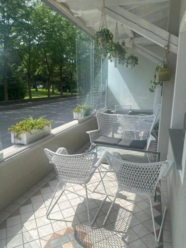 a porch with chairs and a table and a window at Franciacorta Rooms 1 in Corte Franca