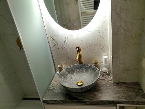 a bathroom with a bowl sink and a mirror at Luxury design Apartment in Chişinău