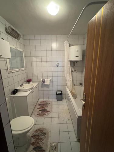 a small bathroom with a toilet and a sink at Magnolia in Ljubuški