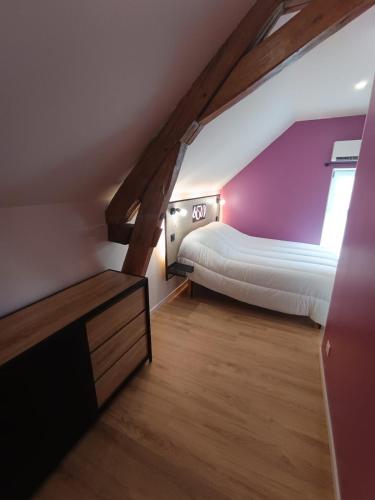 - une petite chambre mansardée avec un lit et une fenêtre dans l'établissement Gîte au cœur des châteaux de la Loire, à Francueil