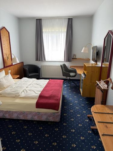 a hotel room with a bed and a desk at Hotel hArz7 in Seesen