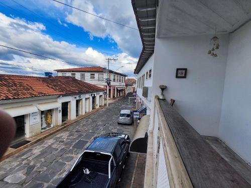 a balcony of a building with cars parked on a street at Pousada Flor de Lis in Diamantina
