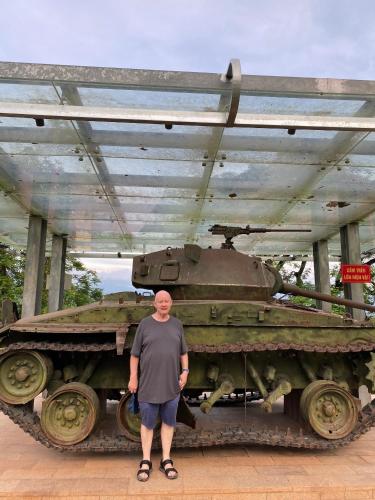 a man standing in front of a tank at Muong Thanh Homestay in Diện Biên Phủ