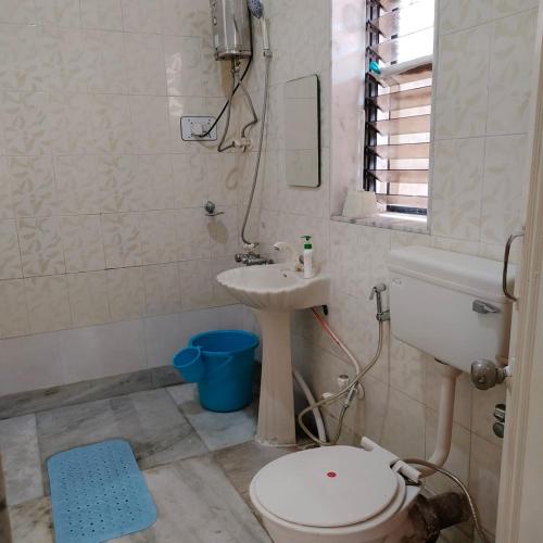 a bathroom with a toilet and a sink at Hill View Quads Villa in Lonavala