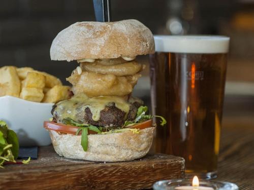 a sandwich on a table next to a glass of beer at The Fairfax Arms in Gilling East