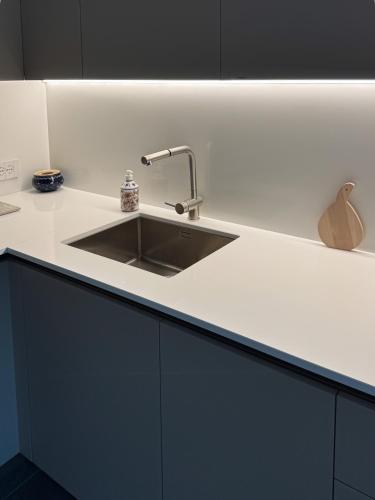 a kitchen with a sink and a counter top at Enrichetta Apartment in Castione Andevenno