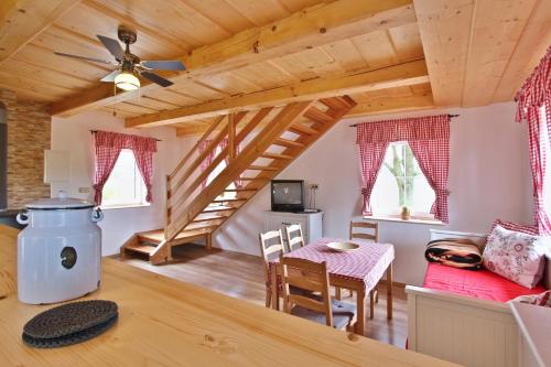 a kitchen and dining room with a wooden ceiling at Chalupy Dolní Chřibská in Chřibská