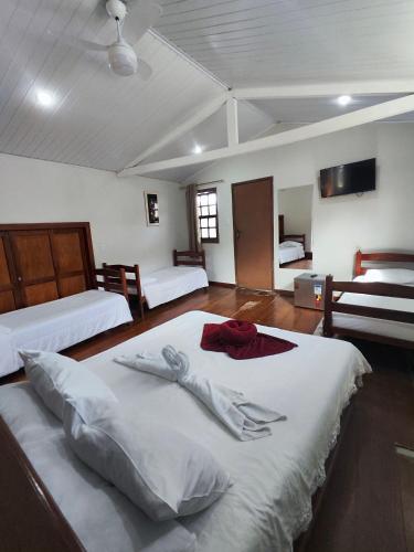 a large room with two beds at Pousada Flor de Lis in Diamantina
