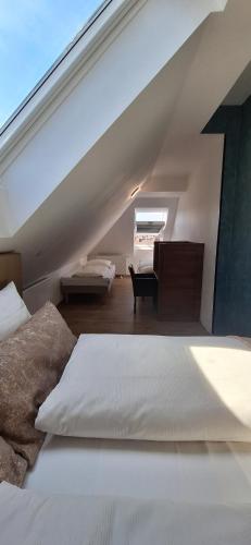 a attic bedroom with a bed and a desk at Hotel Villa Sophia in Cologne