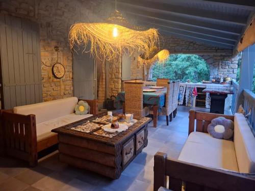 a living room with a couch and a table at Demeure de charme OLIVIRA in Vesseaux