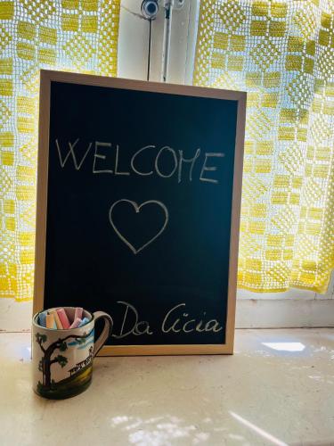 a chalkboard with a heart written on it next to a cup at Casa Da Cicia in Casiano