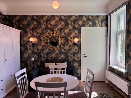 a dining room with a table and a couch at Green Villa in Pärnu