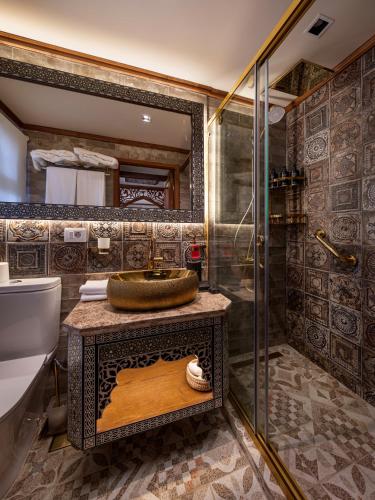 a bathroom with a sink and a shower at EL Hanim Dahabeeyah in Luxor
