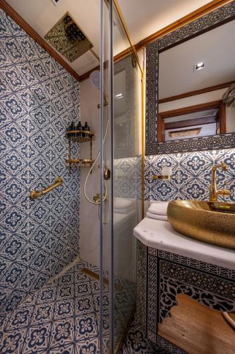 a bathroom with a sink and a shower at EL Hanim Dahabeeyah in Luxor