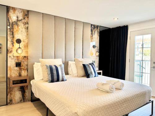 a bedroom with a large bed with two towels on it at Les Suites des Chutes - La Royale in Boischâtel