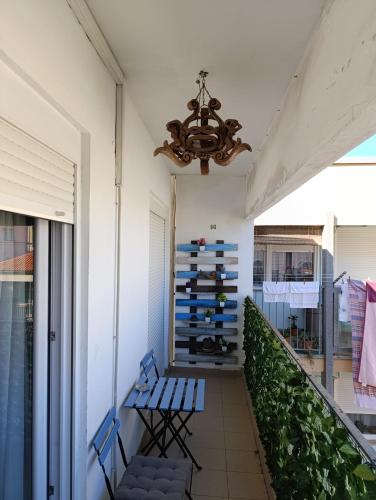 a balcony with two blue benches and a chandelier at VIVA RIVA ZADAR in Zadar