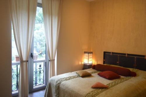 a bedroom with a bed and a large window at Tufenkian Avan Dzoraget Hotel in Dzoraget
