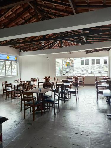 a dining room with tables and chairs in a building at HOTEL ESTAÇÃO in Diamantina