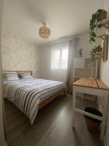une chambre avec un lit, une table et une fenêtre dans l'établissement Villa on Arcachon Bay, à Audenge