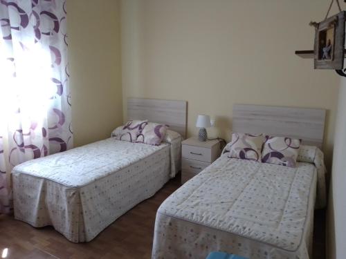 a bedroom with two beds and a window at Casa SUROESTE - Zona El Colorado, Conil de la Frontera in Roche