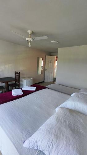 a large white bed in a bedroom with a ceiling at HOTEL ESTAÇÃO in Diamantina