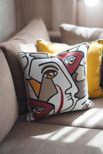 a pillow with an image of a head on a couch at 5 min drive from Train Station with Parking, Air Conditioning & IPTV -Ideal for CAN 2025 in Kenitra