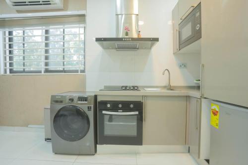a kitchen with a washing machine and a sink at Accra Luxury Apartments @ Silicon Square in Accra