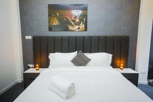 a bedroom with a large white bed with two night stands at Accra Luxury Apartments @ Silicon Square in Accra