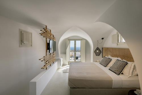 a bedroom with a bed in a white room at Casa Luz in Pyrgos