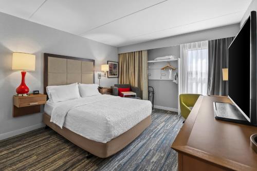a hotel room with a bed and a desk at Hampton Inn Toledo-South/Maumee in Maumee