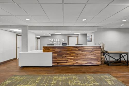 an office lobby with a welcome sign on the wall at Hampton Inn Toledo-South/Maumee in Maumee