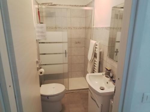 a small bathroom with a toilet and a sink at ANITA B&B in Uscio