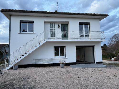 a white house with a staircase on top of it at Coin paisible in Bordes