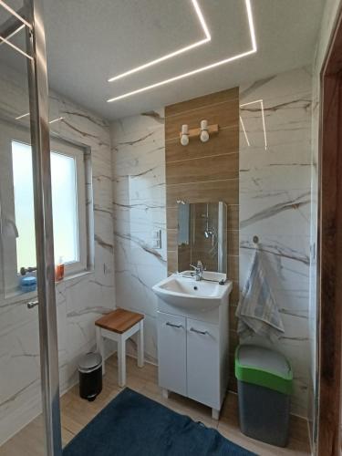 a bathroom with a sink and a mirror at Przy wodzie - Jacnia in Jacnia