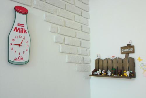 a clock on a wall next to a brick wall at Residence Unicorn in Seoul