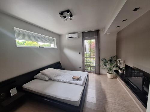 a bedroom with a bed and a fireplace at Private Family Villa in Budaörs