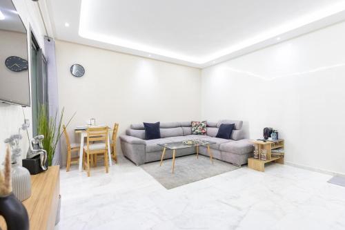 a living room with a couch and a table at Miramar Residence Beach in Mohammedia
