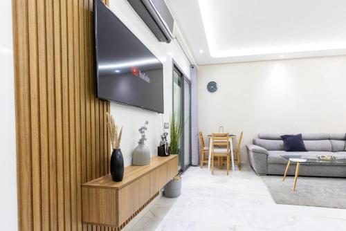 a living room with a flat screen tv on a wall at Miramar Residence Beach in Mohammedia