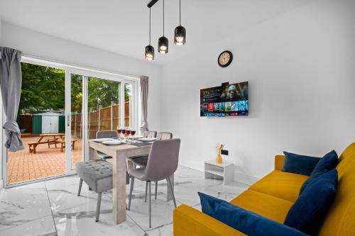 a living room with a yellow couch and a table at NEC BHX Free Parking Luxury Prestige Cosy Elegance in Birmingham
