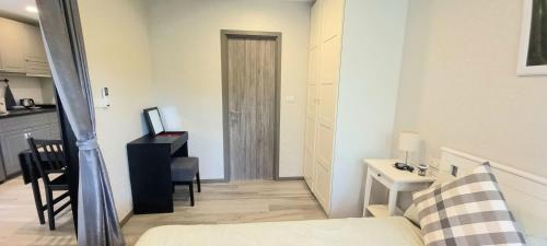 a living room with a bed and a desk in a room at B8 Ватсап669З5В2I976 in Nai Yang Beach