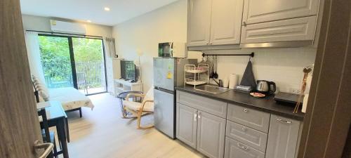 a kitchen with a sink and a refrigerator in it at B8 Ватсап669З5В2I976 in Nai Yang Beach