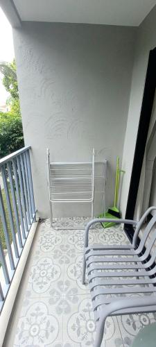 a white bench sitting on a balcony with a tile floor at B8 Ватсап669З5В2I976 in Nai Yang Beach
