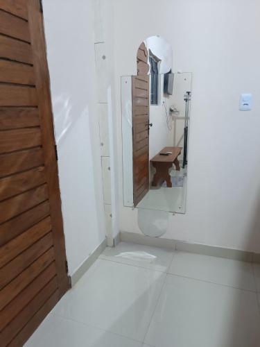 a bathroom with a toilet and a mirror at Suite das Mangueiras I in Soure