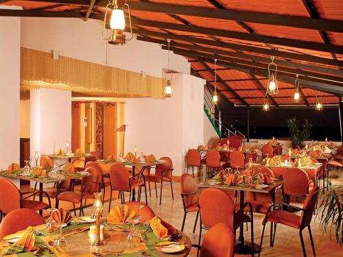 a large banquet hall with tables and chairs at Classic Sarovar Portico Trivandrum in Trivandrum