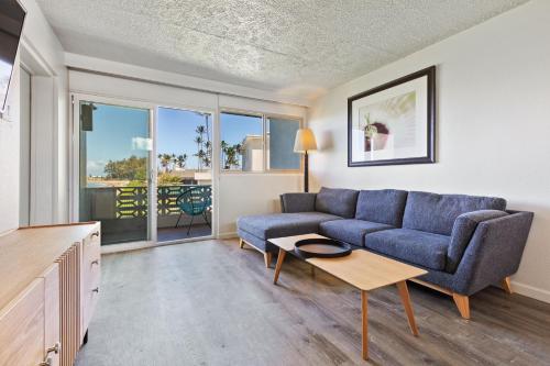 a living room with a couch and a table at Maui Seaside Hotel in Kahului