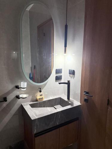 a bathroom with a sink and a mirror at madintay b8 modern cozy studio in Madinaty