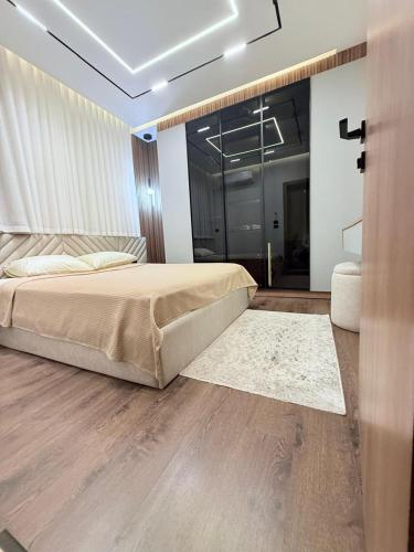 a bedroom with a bed and a sliding glass door at madintay b8 modern cozy studio in Madinaty