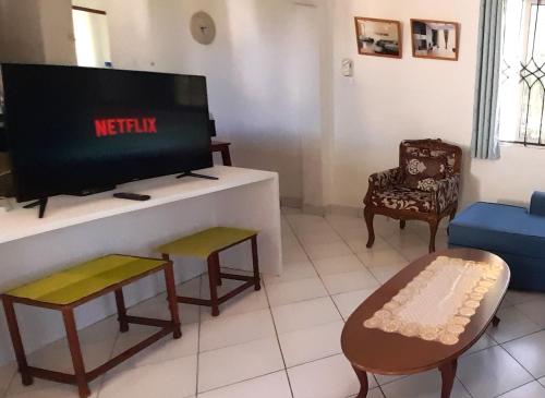 a living room with a flat screen tv and a couch at Royal Palms Apartment D4 - Mtwapa in Mtwapa